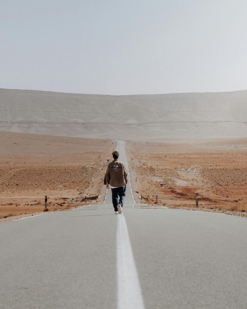 A man traveler walking on the road-affordable flights and hotels-cheap-flights-travel-deals-this-weekend-cheap-hotels-rental-cars-budget-car-rental-cheap